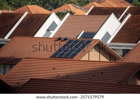 Multiple rooftops with solar panels attached attempting to support green energy transition to renewable energy