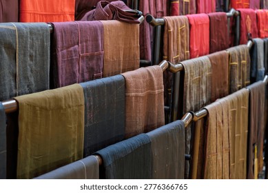 multiple rows of hangers displaying various monk robes