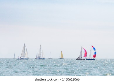 Multiple Sailboats Sailing On The Ocean On A Sunny Day