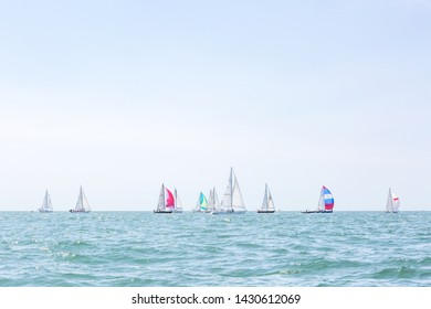 Multiple Sailboats Sailing On The Ocean On A Sunny Day