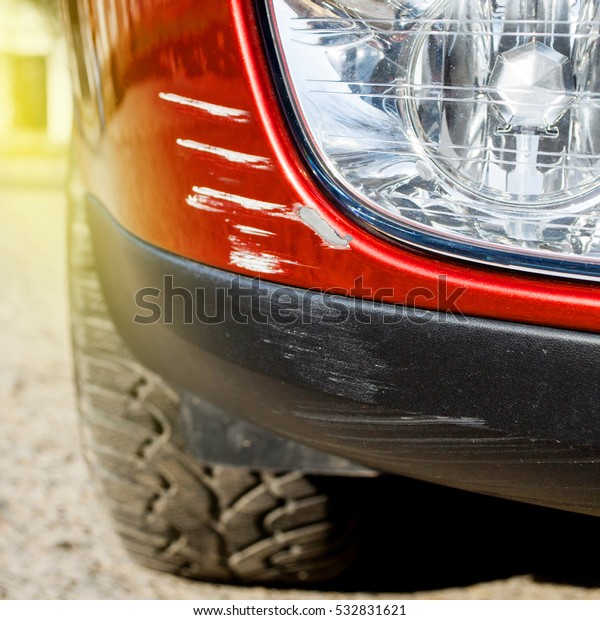 Multiple scratches on a car\'s bumper - right\
under the headlight