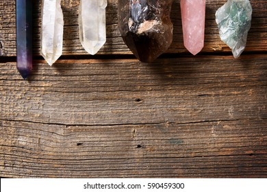 Multiple semi precious gemstones on wooden board
fluorite, quartz, smoky quartz, rose quartz.
