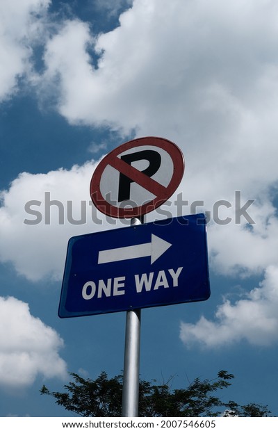 multiple\
sign road says no parking and one way\
direction