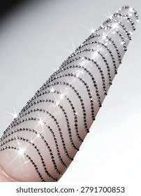 Multiple silver bracelets on a pink surface