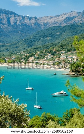Multiple small boats float in serene blue waters surrounded by lush mountains and trees in Thassos, Greece