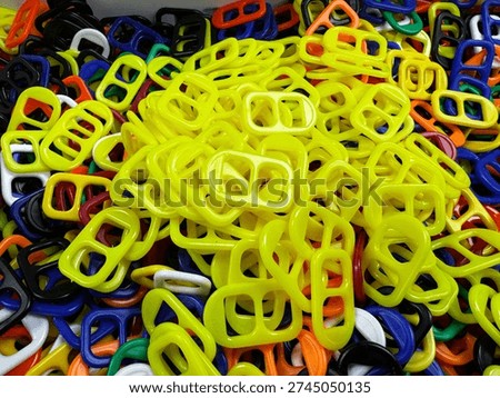 Multiple soda can pull tabs with a variety of colors