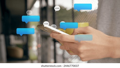 Multiple speech bubbles floating against mid section of caucasian woman using smartphone. Social media networking technology concept
