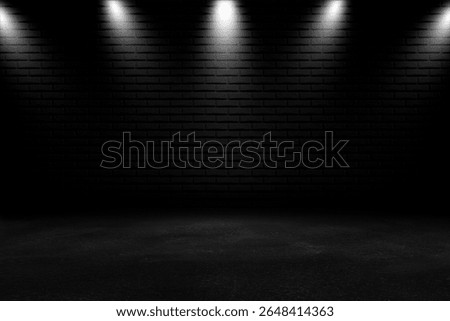 Multiple spotlights cast dramatic light onto a black brick wall and dark floor, creating a moody and professional studio scene for product presentations.