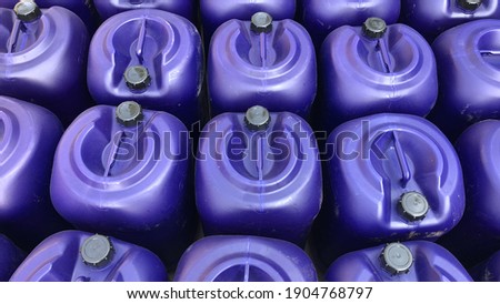 Multiple of storage dark blue plastics gallons, 20-25 litre, for container liquid chemistry, water, for used in industry. Top view.