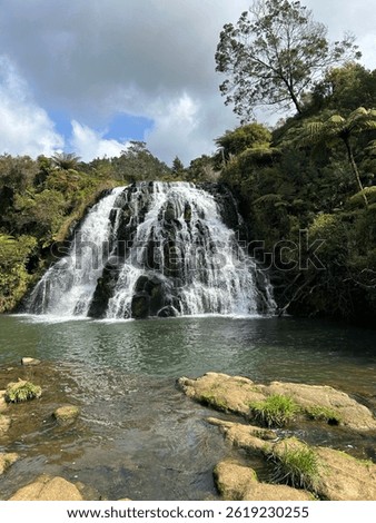 Multiple streams making a beautiful wide waterfall surrounded by native bush