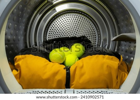 Multiple tennis balls with clothes in tumble dryer to  ensure that down is loosened and feathers do not stick together, fluff up laundry, pillows, sheets
