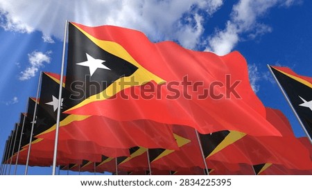 Multiple Timor Leste flags waving on blue sky