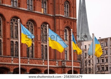Multiple ukrainian flags waving in front of Rotes Rathaus builidng, Berlin city hall, representing support, political unity,  international solidarity and support for Ukraine