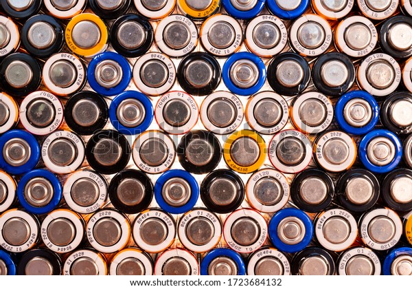 Multiple\
used AA alkaline batteries are seen arranged in a pile. Closeup\
front view from the minus side of the\
battery.