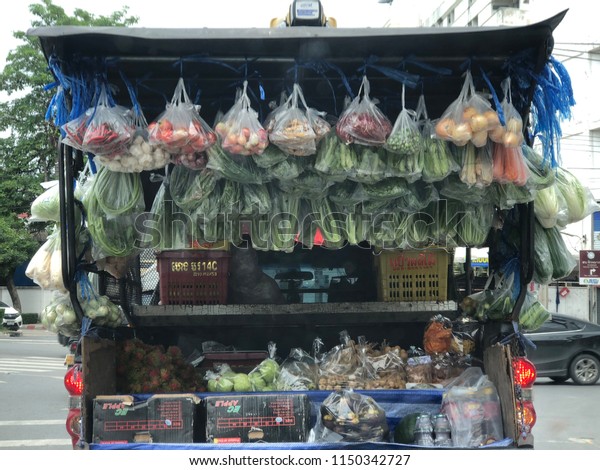 Multiple vegetables, fruits and everything food\
packaging in plastic bag and hanging for customers to buy.\
Supermarket on mobile truck or pickup truck, delivery shopping,\
Bangkok, Thailand,\
2018.