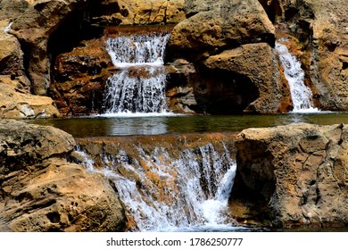 Multiple Waterfalls Flowing Out Of The Rocks