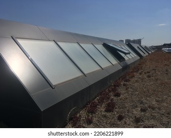 Multiple Window Systems On Flat Roof. Skylight Window On The Flat Roof. Modern Materials Of Public Buildings. Modern Architecture. Open Window. Materials Of Buildings. Roof Window. Technology.