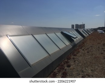 Multiple Window Systems On Flat Roof. Skylight Window On The Flat Roof. Modern Materials Of Public Buildings. Modern Architecture. Open Window. Materials Of Buildings. Roof Window. Technology.