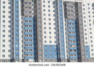 Multiple Windows On A Large Building In The City In Blue And White