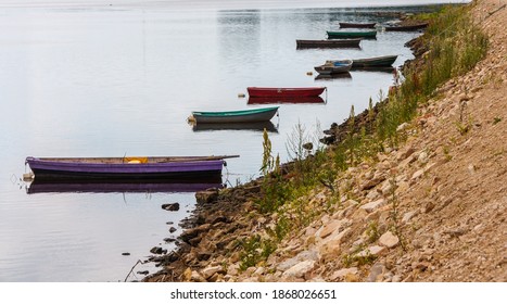 Multiple Wooden Fishing Boats Parked On Coast Of River