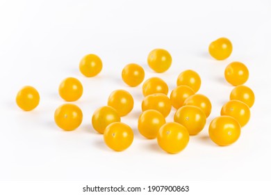 multiple yellow cherry tomatoes on a white background with shadow