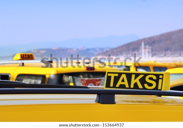 Multiple\
yellow taxi cars at taxi station in\
Turkey