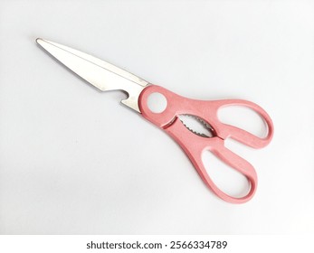 A multipurpose kitchen scissors with sharp stainless-steel blade and pink handle, displayed on white background. It has stylish and durable design, ideal for cutting, kitchen and household tools. - Powered by Shutterstock