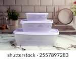 Multipurpose plastic food containers for vegetables, meats, cheeses on a kitchen counter 