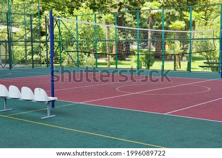 A multipurpose playground with rubber coating and markings for tennis, basketball and volleyball.