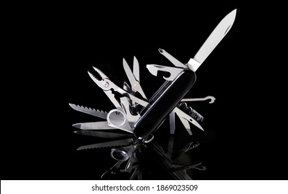 multipurpose pocket knife on black background