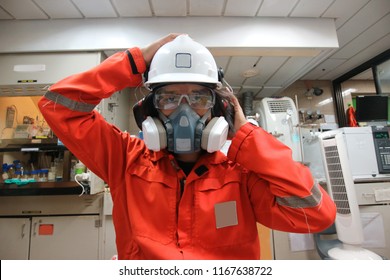        Multi-purpose respirator half mask for toxic gas protection.The man prepare to wear Multi-purpose respirator half mask.                        