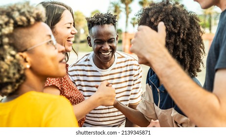Multiracial best friends having fun laughing out loud outdoors - Group of young people enjoying summertime day out - Teenagers joking together in college campus - Friendship concept - Shutterstock ID 2139345871
