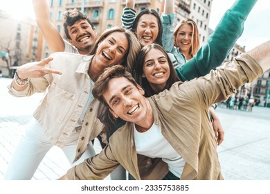 Multiracial best friends having fun outside - Group of young people smiling at camera outdoors - Friendship concept with guys and girls hanging out on city street  - Powered by Shutterstock