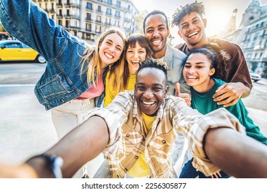 Multiracial best friends taking selfie walking on city street - Happy young people having fun enjoying day out - Diverse teens laughing at camera on summer vacation - Friendship and tourism concept - Powered by Shutterstock