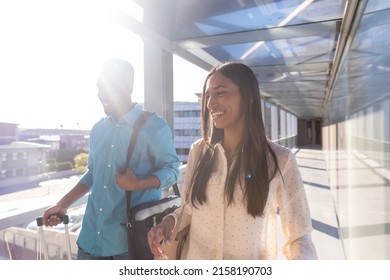 Multiracial Business Colleagues Walking In Corridor At Airport On Sunny Day. Unaltered, Occupation, Business Travel And Transportation Concept.