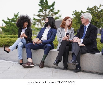 Multiracial Business People Eating Fresh Poke Food During Lunch Break Outside - Focus On The Man With Prosthetic Leg