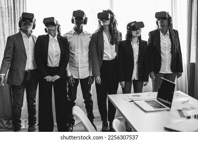 Multiracial business people wearing vr goggles inside office - Main focus on right headset - Black and white editing - Shutterstock ID 2256307537
