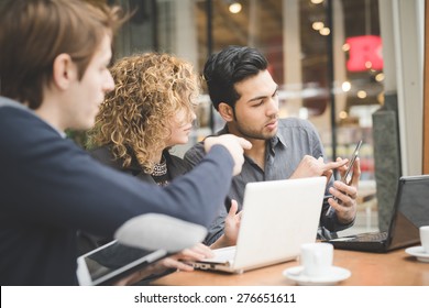 Multiracial business people working connected with technological devices at the bar - Powered by Shutterstock