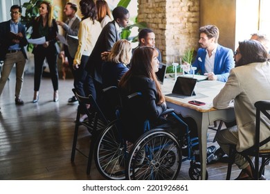 Multiracial Business People Working On Sustainable Innovation Project - Focus On Asian Woman Sitting On Wheelchair