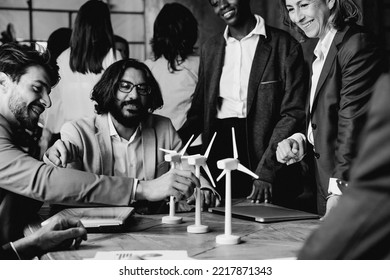 Multiracial Business People Working On Green Eco Sustainable Energy Project Inside Office - Alternative Renewable Electricity Concept - Black And White Editing - Soft Focus On Left Man Ear