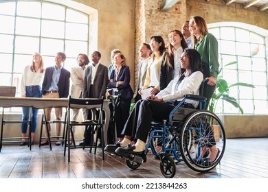 Multiracial businesspeople smiling at the camera in a modern office. Diverse team of businesspeople and inclusivity concept - Powered by Shutterstock