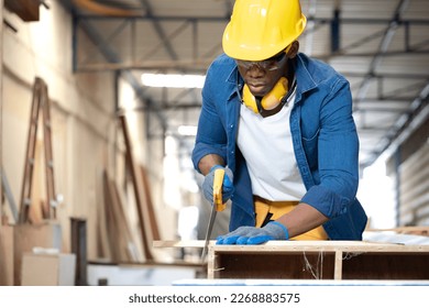 Multiracial carpenter working with skill in carpentry workshop. Professional joiner works with manual tools in woodworking. Portrait of woodworker making or repairing furniture. Craftsman industry - Shutterstock ID 2268883575