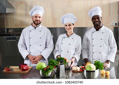 Multiracial chefs team smiling by modern kitchen counter - Powered by Shutterstock