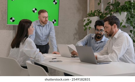 Multiracial colleagues businessmen businesswoman work corporate business discussion team leader signing document agreement at office meeting with interactive board green screen chroma key copy space - Powered by Shutterstock