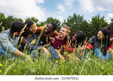 Multiracial Community Of Generation Z Happy Friends Having Fun Sitting In The Grass - Lifestyle Concept Of Multiethnic Youth Culture, Diversity, Oneness, Trust