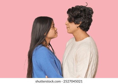 Multiracial couple in love gazing at each other in studio - Powered by Shutterstock