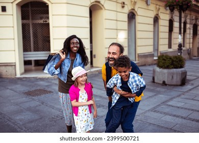 Multiracial couple walking with mixed children in city - Powered by Shutterstock