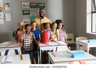 Multiracial elementary students and african american young male teacher with fire extinguisher. unaltered, education, firefighter, safety, protection, teaching and school concept. - Powered by Shutterstock