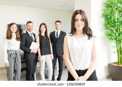 Multiracial Employees Looking At Beautiful Supervisor Setting Example For Them In Office