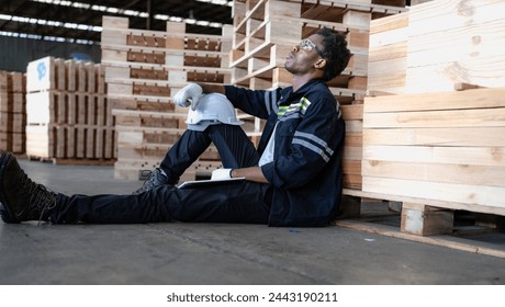 Multiracial engineer, worker sitting resting on floor feel tired from overworked in factory. Young adult technician feel weak, stress, exhausted, worried, frustrated, unhappy, hopeless, or headache